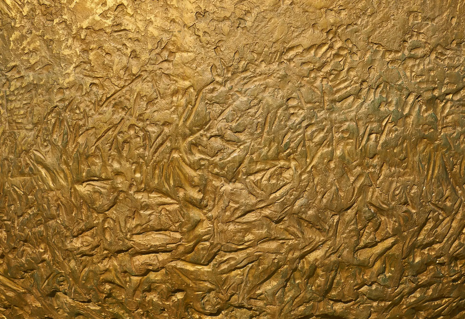 a close up of a metal surface with gold paint