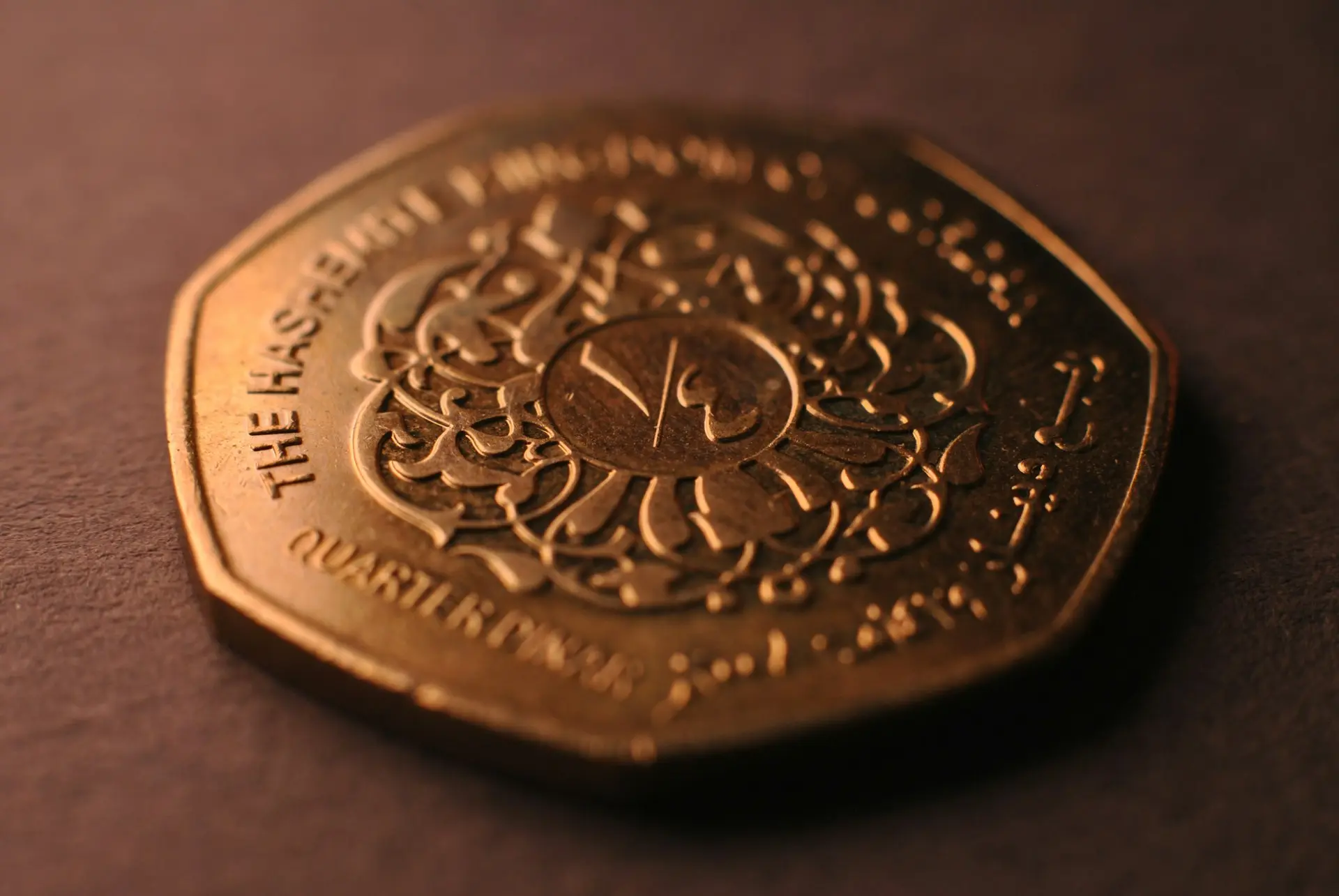 A close up of a gold coin on a table